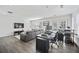 Open-concept living room featuring hardwood floors, modern decor, and a comfortable seating area with a gray sectional sofa at 8540 Hope Mews Ct, Atlanta, GA 30350