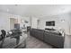 Spacious living room with hardwood floors, a large sectional sofa, an office area, and modern decor at 8540 Hope Mews Ct, Atlanta, GA 30350