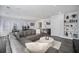 Open-concept living room featuring hardwood floors, modern decor, and a large sectional sofa with decorative pillows at 8540 Hope Mews Ct, Atlanta, GA 30350