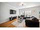 Comfortable living room featuring hardwood floors, neutral colors, and a large window at 8540 Hope Mews Ct, Atlanta, GA 30350