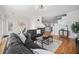 Spacious living room with hardwood floors, a fireplace, and an open floor plan at 8540 Hope Mews Ct, Atlanta, GA 30350