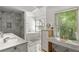 Spa-like bathroom featuring a soaking tub, marble shower, double vanity, and bright window at 2316 Defoors Ferry Nw Rd, Atlanta, GA 30318