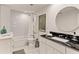 Elegant bathroom featuring subway tile shower, black granite countertops, and round mirror at 2316 Defoors Ferry Nw Rd, Atlanta, GA 30318