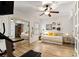 Cozy bedroom with hardwood floors, a daybed, mirrored closet doors, and a ceiling fan at 2316 Defoors Ferry Nw Rd, Atlanta, GA 30318