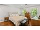 Inviting bedroom with hardwood floors, a plush bed, and natural light from two windows at 2316 Defoors Ferry Nw Rd, Atlanta, GA 30318