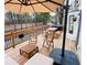 Outdoor deck area with comfortable seating, dining set, umbrella, and grill for outdoor entertaining and relaxation at 2316 Defoors Ferry Nw Rd, Atlanta, GA 30318