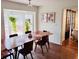 Dining room featuring hardwood floors, hanging plants, and a sliding door, blending indoor and outdoor living at 2316 Defoors Ferry Nw Rd, Atlanta, GA 30318