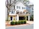 Charming two-story home with dark blue front door, upper deck, well-maintained landscaping, and a garage at 2316 Defoors Ferry Nw Rd, Atlanta, GA 30318