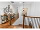 Bright hallway features hardwood floors and a gallery wall of framed prints, illuminated by a modern pendant light at 2316 Defoors Ferry Nw Rd, Atlanta, GA 30318