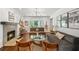 Bright living room featuring hardwood floors, a fireplace, and abundant natural light from a bay window at 2316 Defoors Ferry Nw Rd, Atlanta, GA 30318