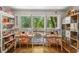 Bright studio with built-in shelving, large windows overlooking the backyard, and desks for creative activities at 2316 Defoors Ferry Nw Rd, Atlanta, GA 30318