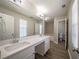 Bathroom with double sink vanity, hardwood-style floors, and updated fixtures at 3534 S Portsmouth Cir, Lithonia, GA 30038