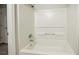 Bright bathroom featuring a built-in white tub and shower combination with updated fixtures at 3534 S Portsmouth Cir, Lithonia, GA 30038