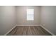 Bright bedroom featuring neutral paint and wood-look flooring, creating a serene and modern space at 3534 S Portsmouth Cir, Lithonia, GA 30038