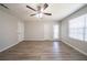 A bright bedroom with neutral paint, wood-look flooring, and a window to bring in natural light at 3534 S Portsmouth Cir, Lithonia, GA 30038