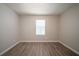 Cozy bedroom featuring neutral paint and wood-look flooring, creating a serene and modern space at 3534 S Portsmouth Cir, Lithonia, GA 30038