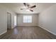 Spacious bedroom featuring modern ceiling fan, neutral paint, wood-look floors, and a large window at 3534 S Portsmouth Cir, Lithonia, GA 30038