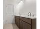 Modern bathroom with a double sink vanity, white countertops, and tiled floors at 727 Crest Line W Trl, Powder Springs, GA 30127