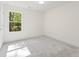 Clean bedroom with gray carpet, white walls, and view of nature from the window at 727 Crest Line W Trl, Powder Springs, GA 30127