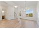 Bright, airy dining room with hardwood floors, chandelier, and large windows at 727 Crest Line W Trl, Powder Springs, GA 30127