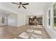 Open concept living space featuring an adjacent kitchen, large windows, and modern flooring at 727 Crest Line W Trl, Powder Springs, GA 30127