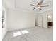 Main bedroom showcasing neutral carpet, fan, and access to the en-suite bathroom at 727 Crest Line W Trl, Powder Springs, GA 30127