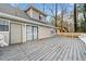 View of the home's back deck with outdoor seating, sliding glass door, and the home's vinyl siding at 806 Longfellow Ct, Stone Mountain, GA 30088