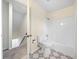 Bright bathroom showcasing a tub-shower combo with a white toilet and eye-catching patterned flooring at 806 Longfellow Ct, Stone Mountain, GA 30088