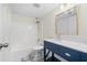 Modern bathroom with a blue vanity, updated fixtures, and a shower-tub combination at 806 Longfellow Ct, Stone Mountain, GA 30088