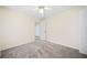 Bright bedroom featuring neutral walls, soft carpet, and a ceiling fan for added comfort at 806 Longfellow Ct, Stone Mountain, GA 30088