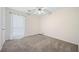 A cozy bedroom featuring neutral walls, carpeted floor, and a ceiling fan with light fixture at 806 Longfellow Ct, Stone Mountain, GA 30088