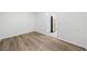 Additional bedroom showing wood flooring and access to the kitchen at 806 Longfellow Ct, Stone Mountain, GA 30088