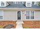 Close-up of the front door with decorative glass, siding, and windows at 806 Longfellow Ct, Stone Mountain, GA 30088