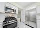 Well-equipped kitchen featuring stainless steel appliances, white cabinets, and ample counter space at 806 Longfellow Ct, Stone Mountain, GA 30088
