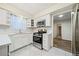 Bright kitchen featuring white cabinets, modern appliances, and subway tile backsplash at 806 Longfellow Ct, Stone Mountain, GA 30088