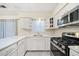 Close-up view of kitchen with white cabinets, stainless steel appliances, and granite countertops at 806 Longfellow Ct, Stone Mountain, GA 30088
