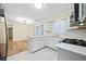 Open kitchen layout with an island, modern appliances, and subway tile backsplash, with views to the living room at 806 Longfellow Ct, Stone Mountain, GA 30088