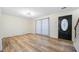 Bright living room featuring hardwood floors, black front door, and neutral paint at 806 Longfellow Ct, Stone Mountain, GA 30088