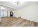 Spacious living room with wood floors, a stylish light fixture, and convenient access to the entryway at 806 Longfellow Ct, Stone Mountain, GA 30088