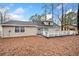 Back exterior of the house with a deck, featuring vinyl siding, windows, and a view of the backyard at 806 Longfellow Ct, Stone Mountain, GA 30088