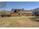 Backyard featuring a lawn and the back of the two-story residence at 105 Bentley Place Way, Covington, GA 30016
