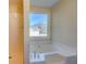 Bathroom featuring a standup shower, a luxurious soaker tub, and a large window at 105 Bentley Place Way, Covington, GA 30016