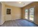 Dining room boasts modern floors, trim, and a view to the backyard at 105 Bentley Place Way, Covington, GA 30016