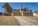 View of the home with a gray roof, matching shutters, attached garage, and long driveway at 105 Bentley Place Way, Covington, GA 30016