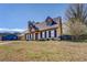 A beautiful home shows well from this angle, showing the yard and an adjacent property at 105 Bentley Place Way, Covington, GA 30016