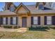 Charming home featuring dormer windows, a covered entry, and well-maintained landscaping at 105 Bentley Place Way, Covington, GA 30016
