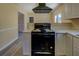 Nicely staged kitchen features a range, lots of counter space, and a modern vent hood at 105 Bentley Place Way, Covington, GA 30016