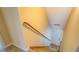 View of carpeted staircase and wood handrail leading to a white door at 105 Bentley Place Way, Covington, GA 30016