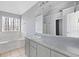 Bright bathroom featuring a soaking tub and window, providing a relaxing retreat at 1116 Oak Hollow Ln, Hampton, GA 30228