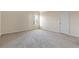 Bedroom with fresh carpeting and a window for natural light, creating a comfortable space at 1116 Oak Hollow Ln, Hampton, GA 30228